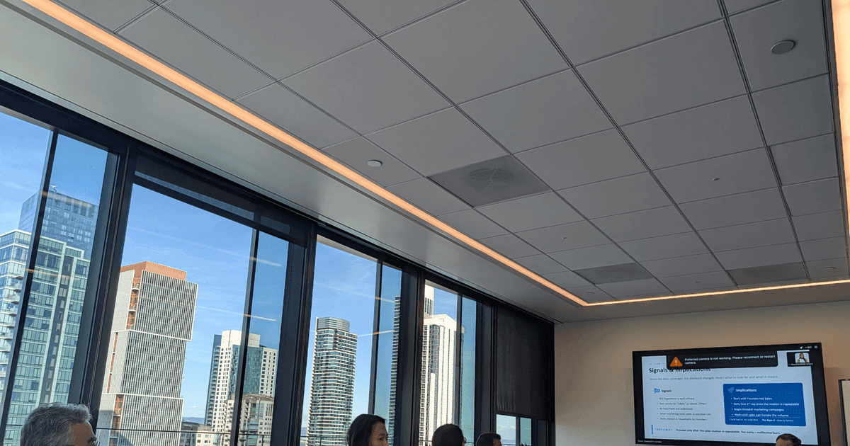 FounderNexus members in a boardroom session with a presentation on screen