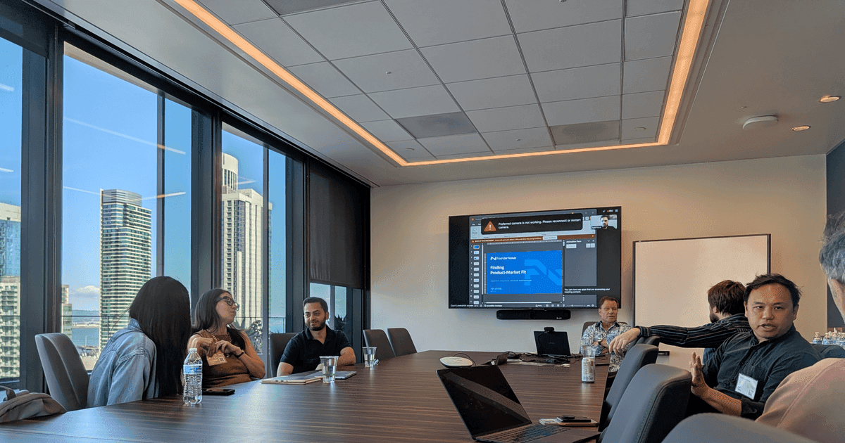 FounderNexus members gathered around a boardroom table for a session